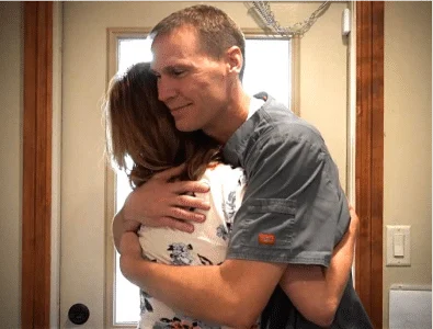 Dr. Eric is hugging the patient gratefully after the dental work.