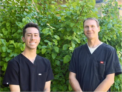 Dr. Eric smiling with one of his workmate