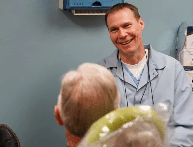 Dr. Eric happily talking with patient