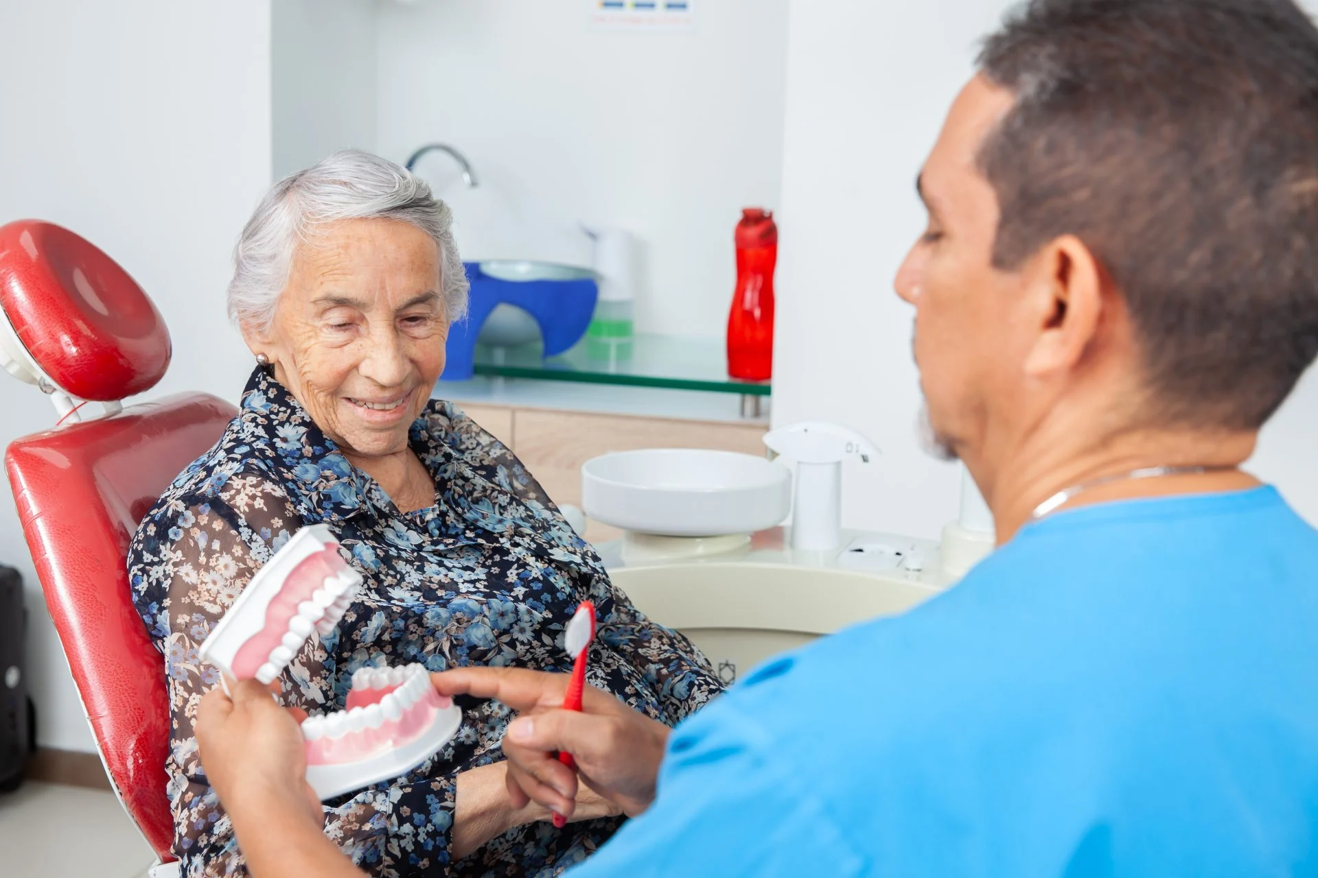 patient looking at a dental model while the dentist explains